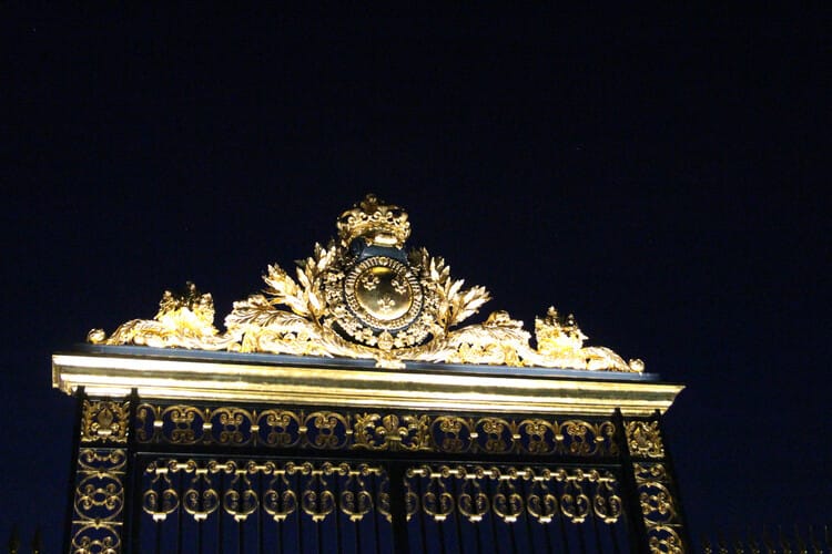 Golden ornate gates at night